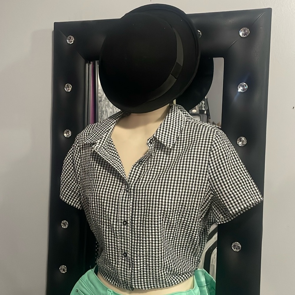 Black hat with velvet band and checkered shirt ties in the back with a knot